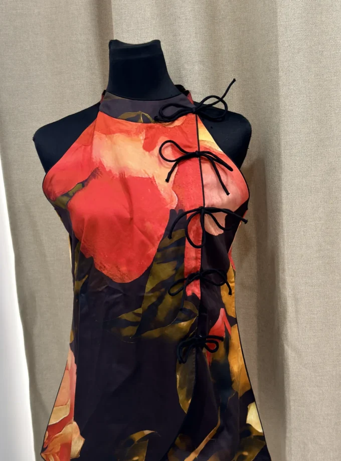 Althea old rose print glaze cotton halter neck top with bows shown alone on a dressform