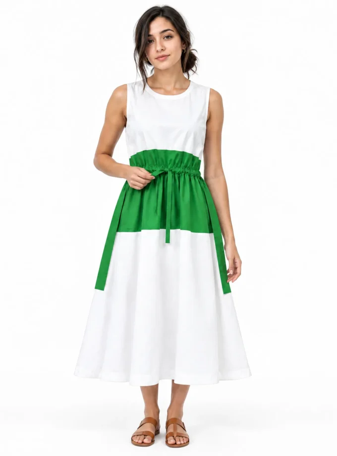 Anora - model wearing the white cotton drawstring dress with a green cotton patch