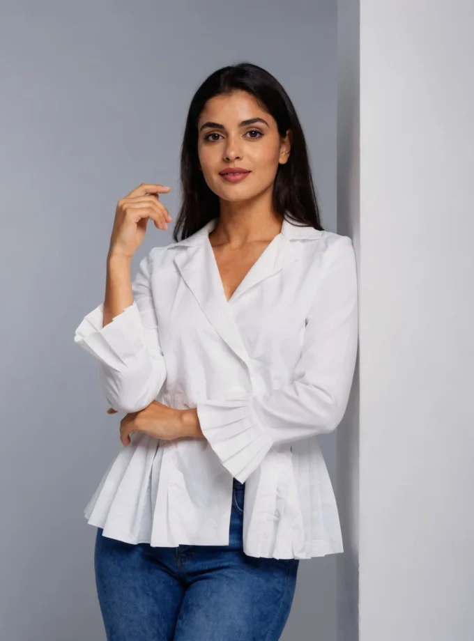 Avani front — model wearing the white cotton pleat blazer shirt with pleated sleeve hem
