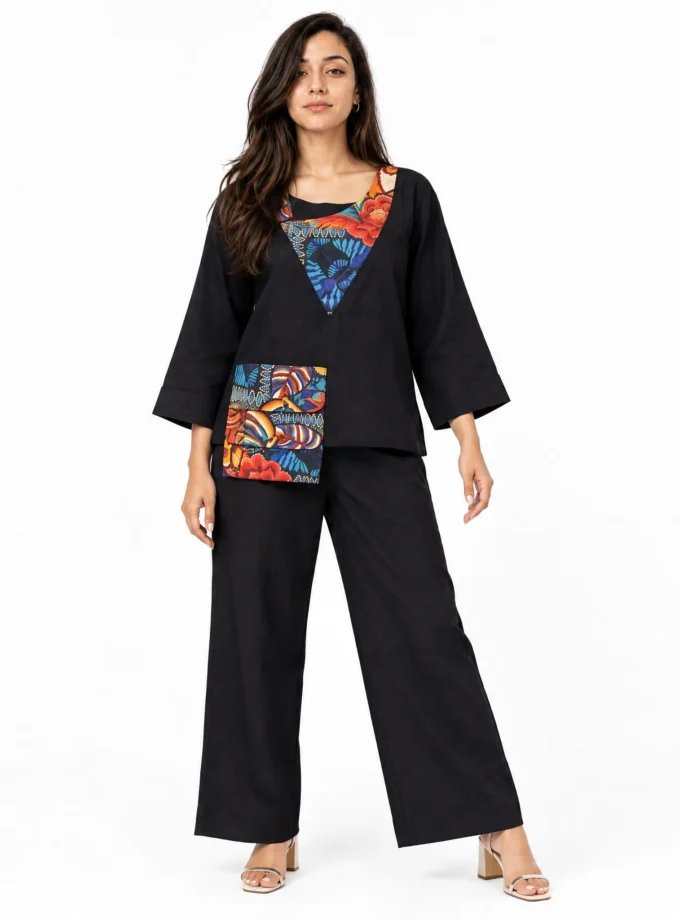 Briar - model wearing the black cotton round neck top with geon print yoke and the black cotton straight fit pants