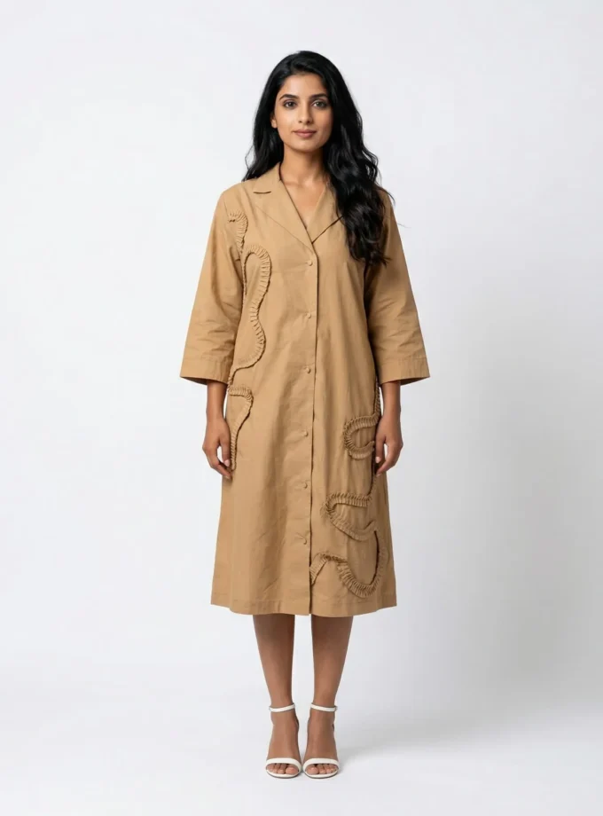 Clarity — model wearing the beige cotton collar lapel A line dress with pleated applique placement