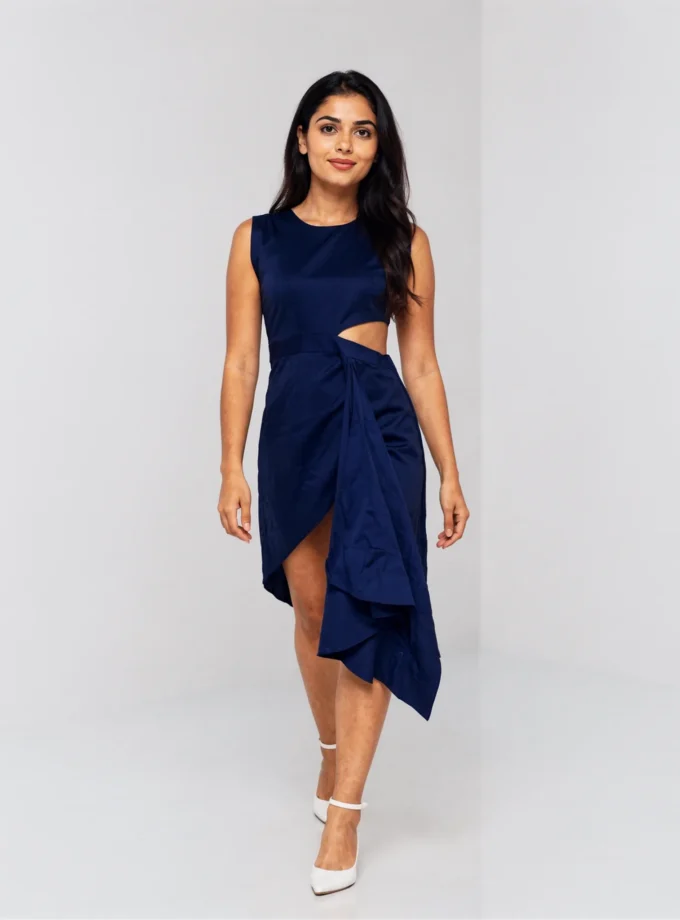 Evie — model wearing the navy cotton asymmetric dress with cutout waist detailing