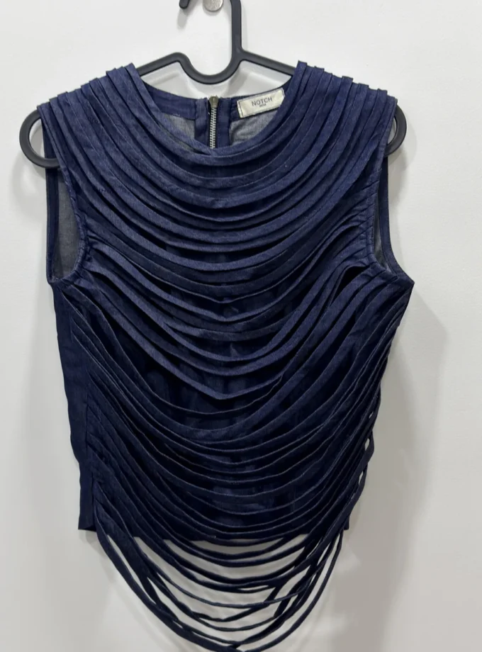Fiorella dark denim crop sleeveless top with loose tassel loops shown alone on a hanger