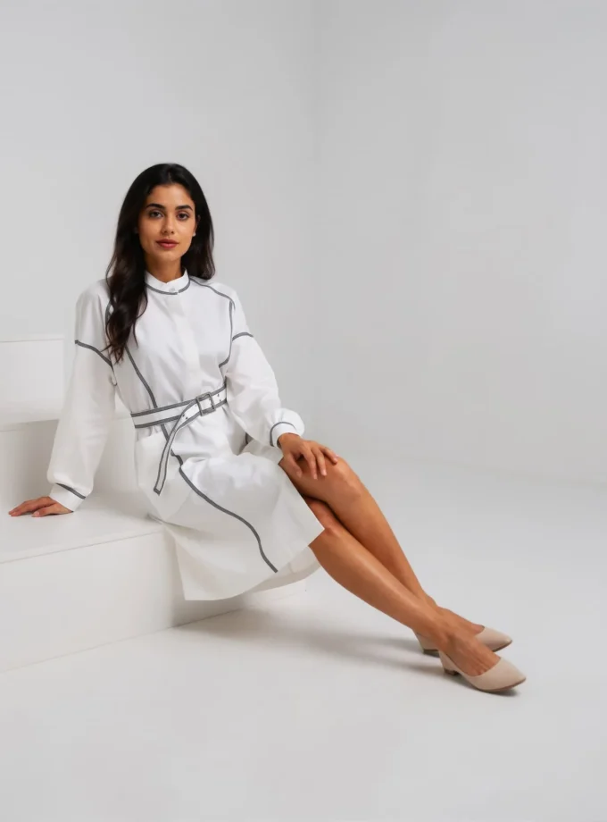 Giselle — model wearing the white denim cotton shirt dress with blue stripe detailing and the metal buckle belt