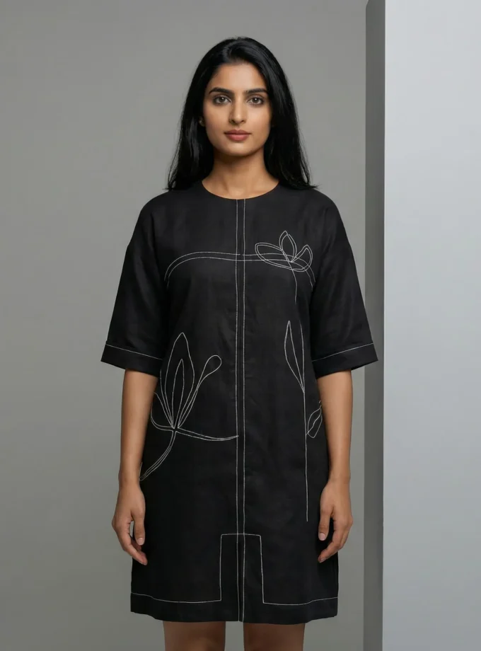 Liana — model wearing the black cotton picture dress with contrast stitch detailing