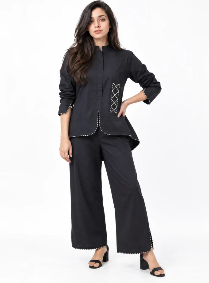 Lyra co-ord set - black cotton mandarin collar shirt with white cross-stitch detail and matching wide-leg trousers