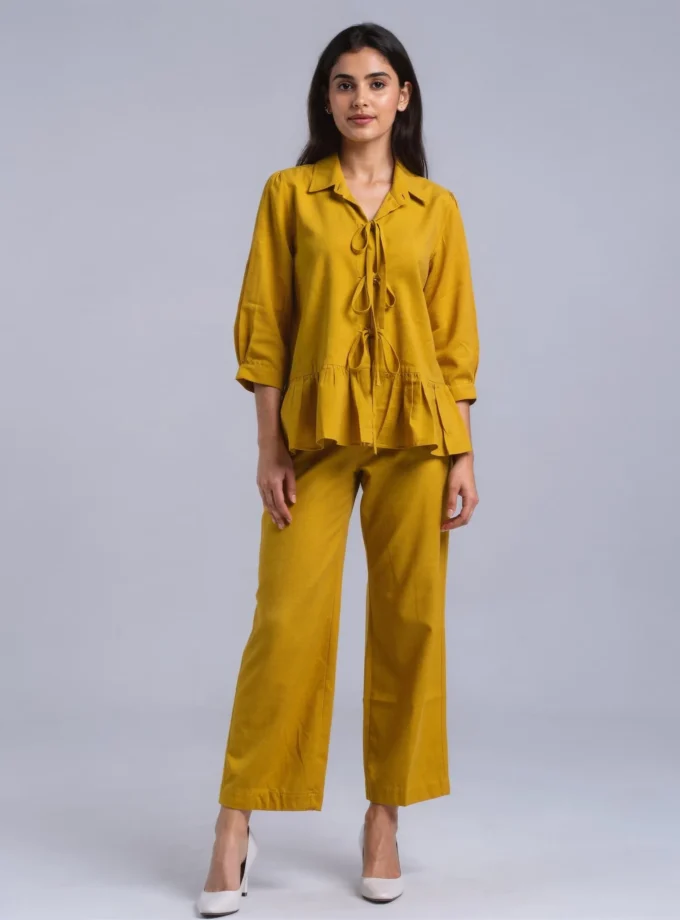 Sylvie — model wearing the mango yellow h-loom tie up top with a gathered hem paired with the mango yellow h-loom straight fit pants