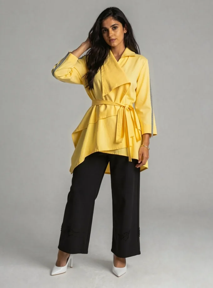 Solace — model wearing the powder yellow wrap round open jacket with a fabric belt tie up