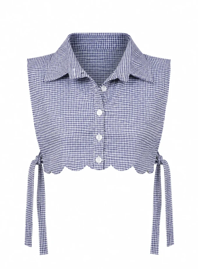 Zinnia blue and white houndstooth print bib with side tie up shown alone on an invisible mannequin