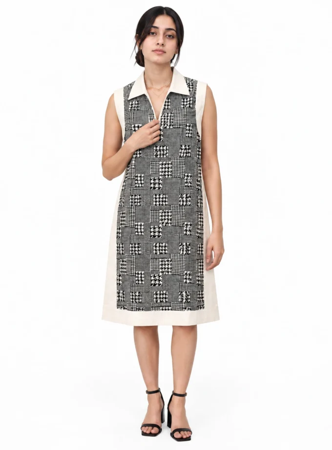 Calyra houndstooth print cotton faux dual dress with white cotton frame, sleeveless, worn by a model