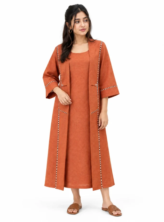 Norelle — model wearing the rust H-LOOM sleeveless slip dress with a round neck under the rust H-LOOM flap-collar open jacket