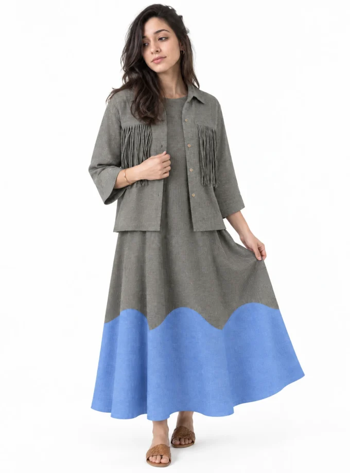 Velisse — model wearing the grey H-LOOM crop shirt with tassel pockets over the grey-blue H-LOOM dress with a scallop patch at the hem