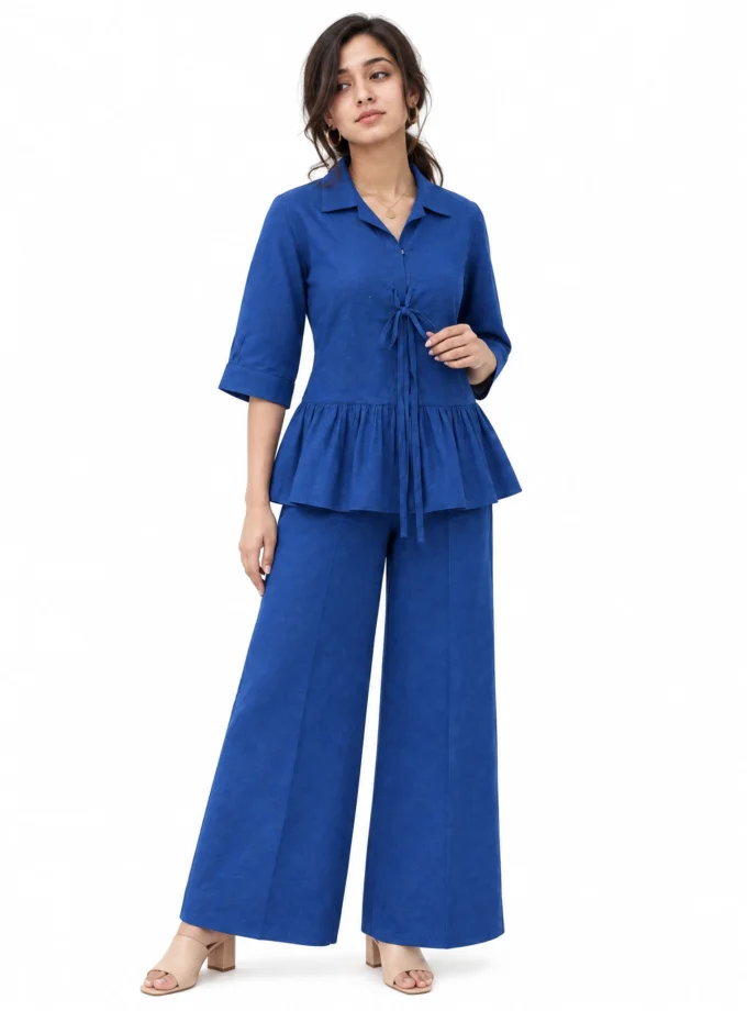 Ysoldie teal H-loom tie-up top with a gathered hem paired with teal H-loom straight fit pants, worn by a model